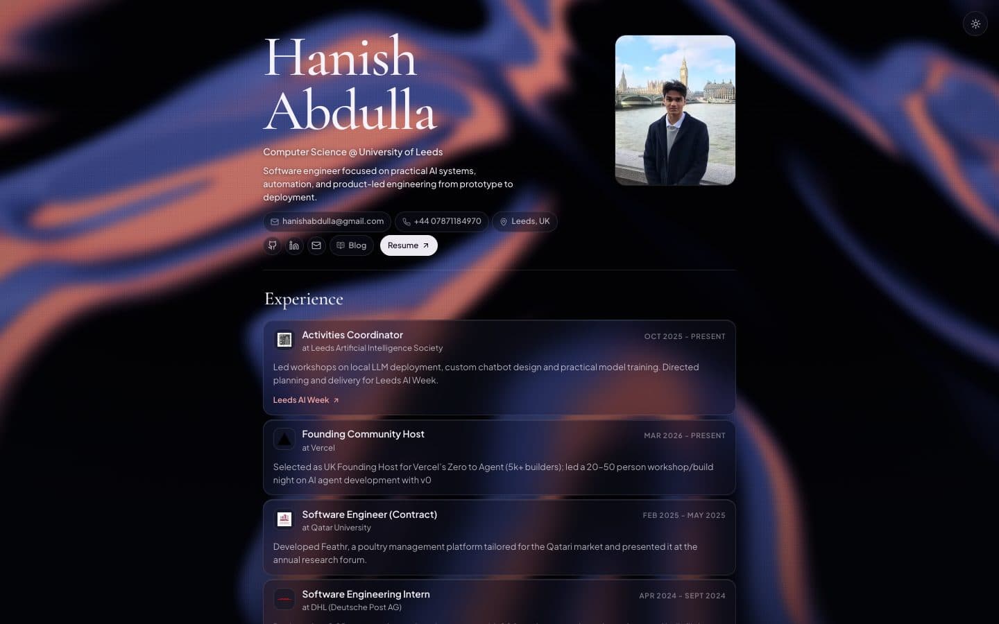 The portfolio homepage on desktop in dark mode, with the silk background behind the hero and experience cards
